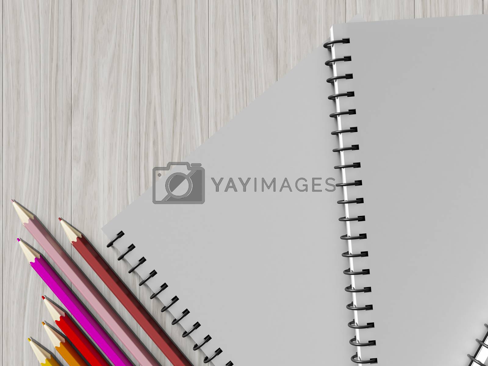 Royalty free image of color pencil on checked notebook on wood background by teerawit