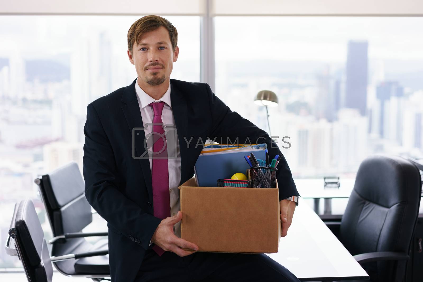 Royalty free image of Portrait Just Hired Business Man With Crate Box Smiling by diego_cervo