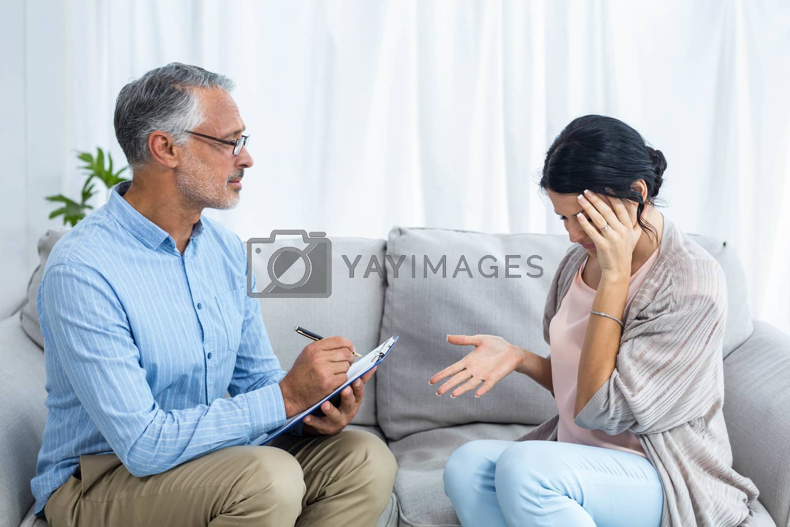 Royalty free image of Therapist consoling a woman by Wavebreakmedia