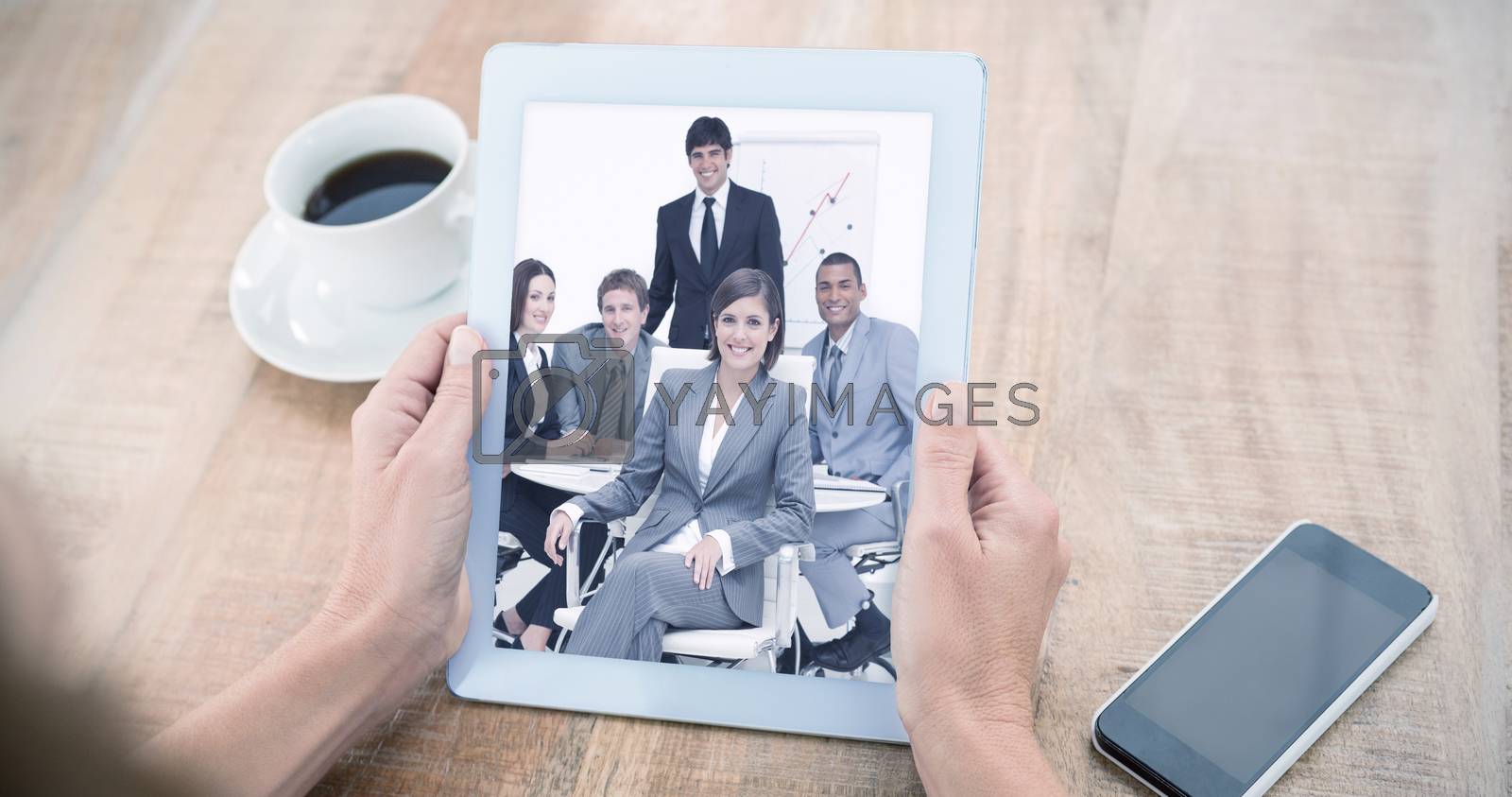 Royalty free image of Composite image of woman using tablet computer at table by Wavebreakmedia