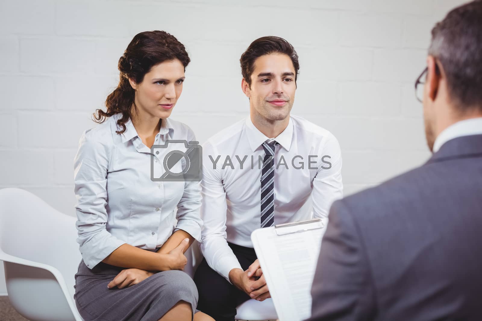 Royalty free image of Clients interacting with businessman by Wavebreakmedia