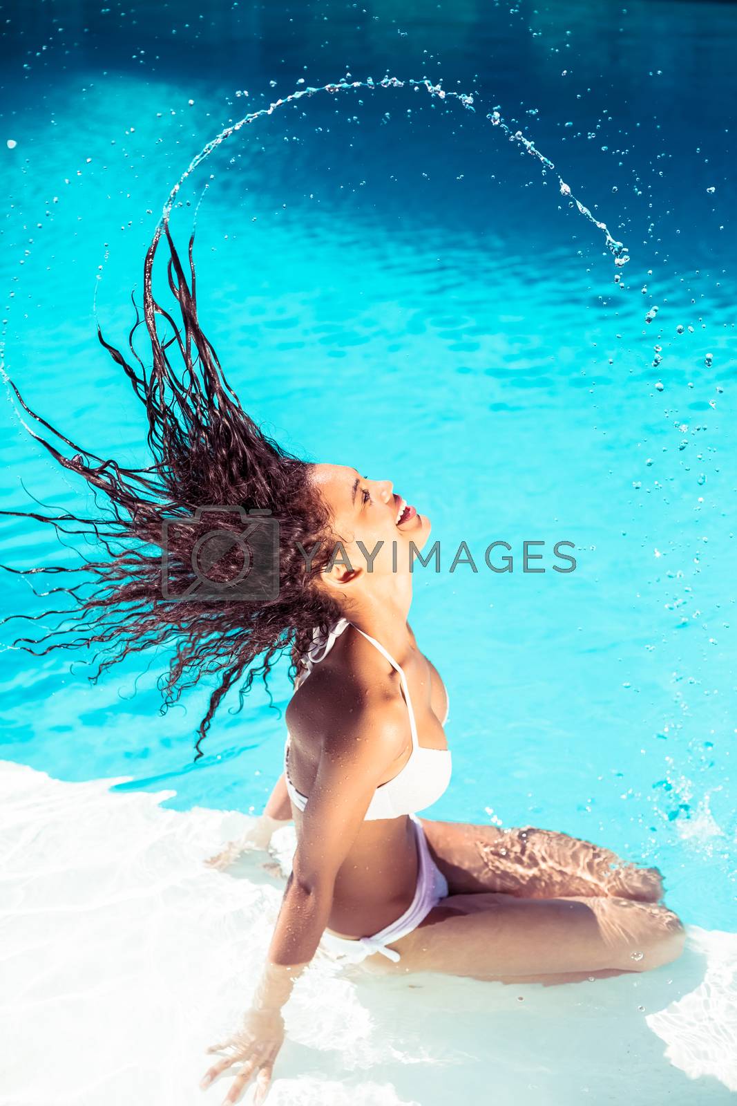 Royalty free image of Beautiful woman tossing her wet hair by Wavebreakmedia