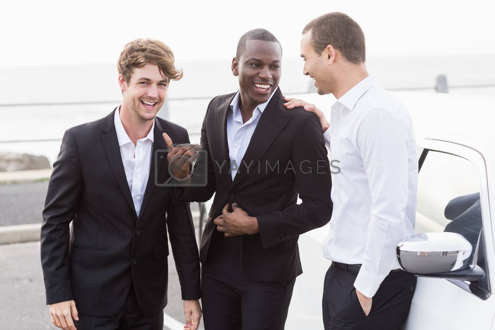 Royalty free image of Well dressed people posing next to a limousine by Wavebreakmedia