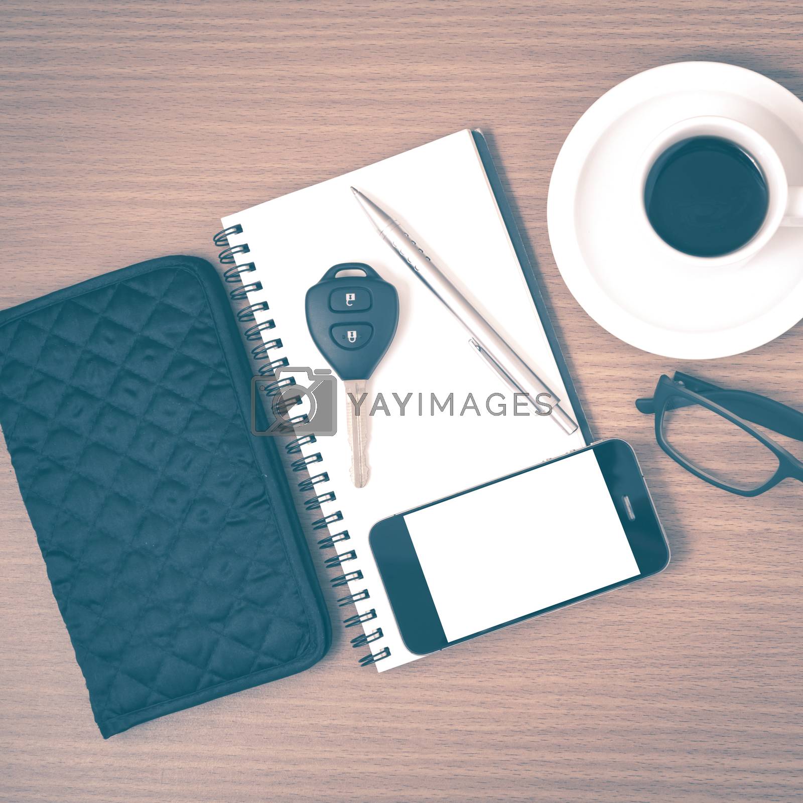Royalty free image of coffee and phone with notepad,car key,eyeglasses and wallet vint by ammza12