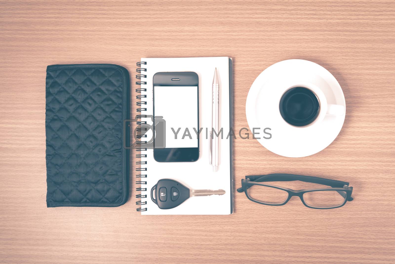 Royalty free image of coffee and phone with notepad,car key,eyeglasses and wallet vint by ammza12