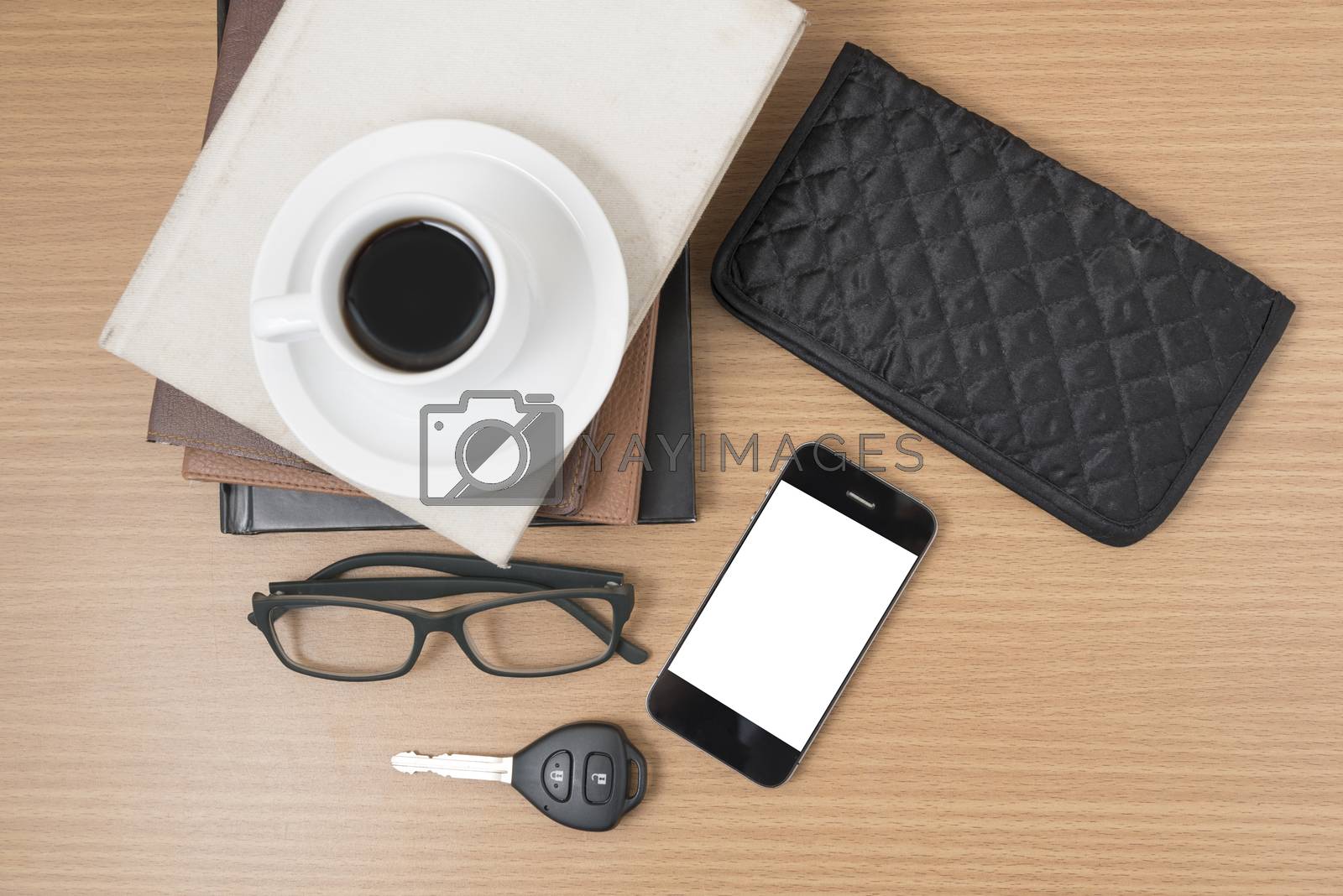 Royalty free image of coffee and phone with stack of book,car key,eyeglasses and walle by ammza12