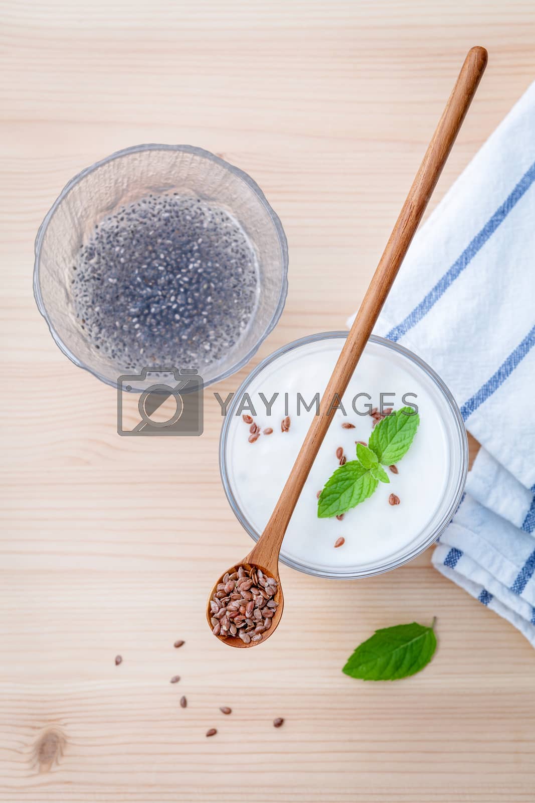 Royalty free image of Nutritious flax seeds with glass of greek yogurt and wooden spoo by kerdkanno