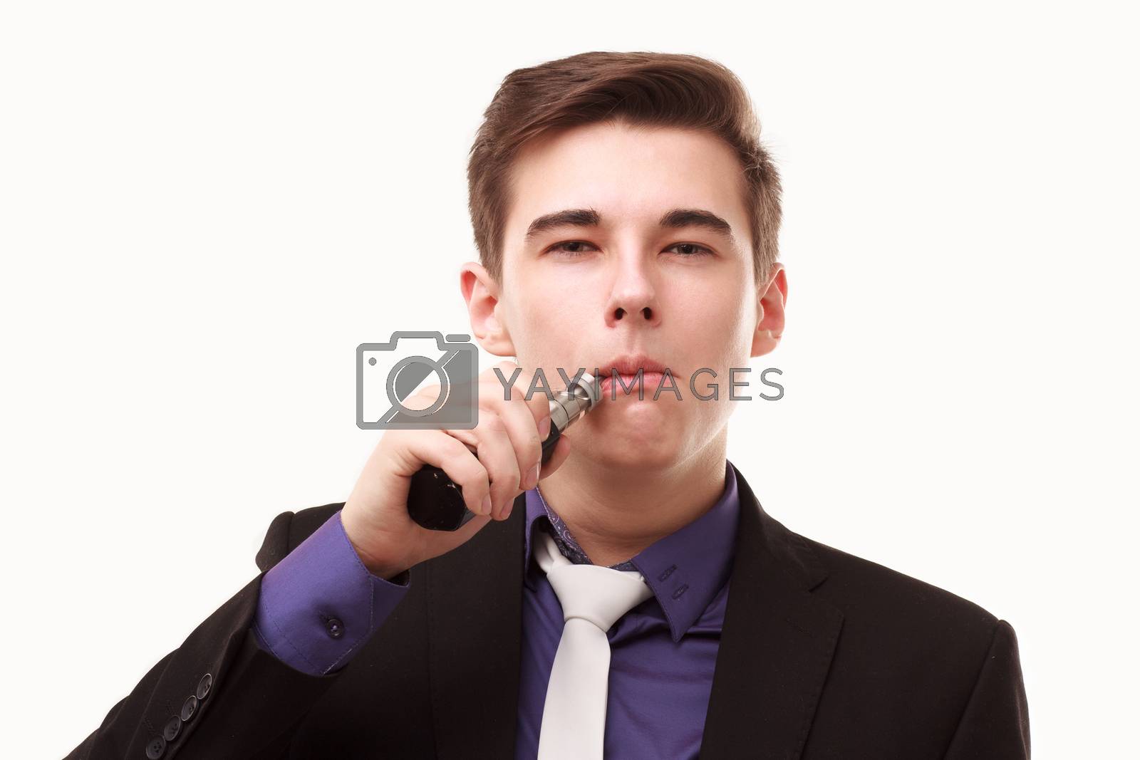 Royalty free image of Portrait of a man in suit smoking an e-cigarette by DmitryOsipov
