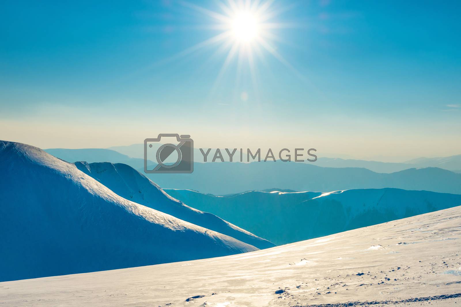 Royalty free image of Bright sun in winter mountains by vapi