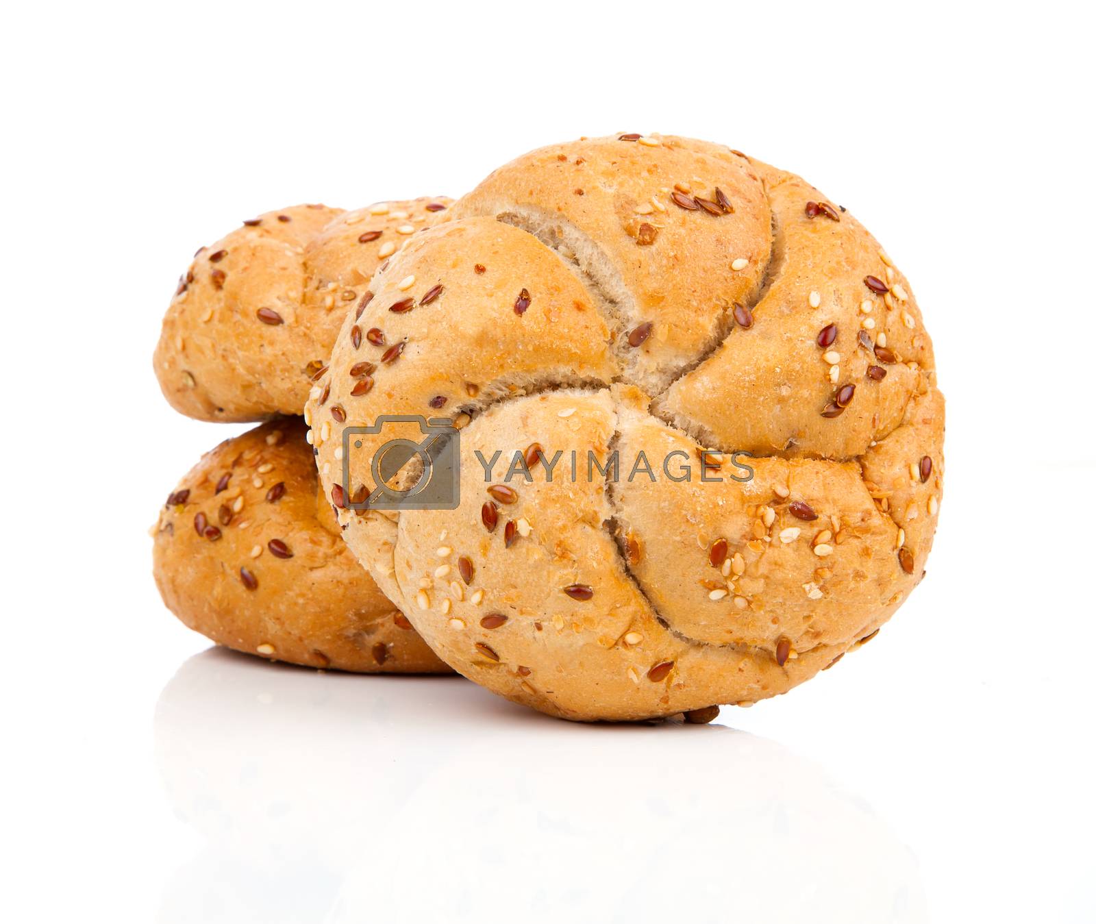 Royalty free image of Kaiser roll with sesame seeds, on a white background by motorolka