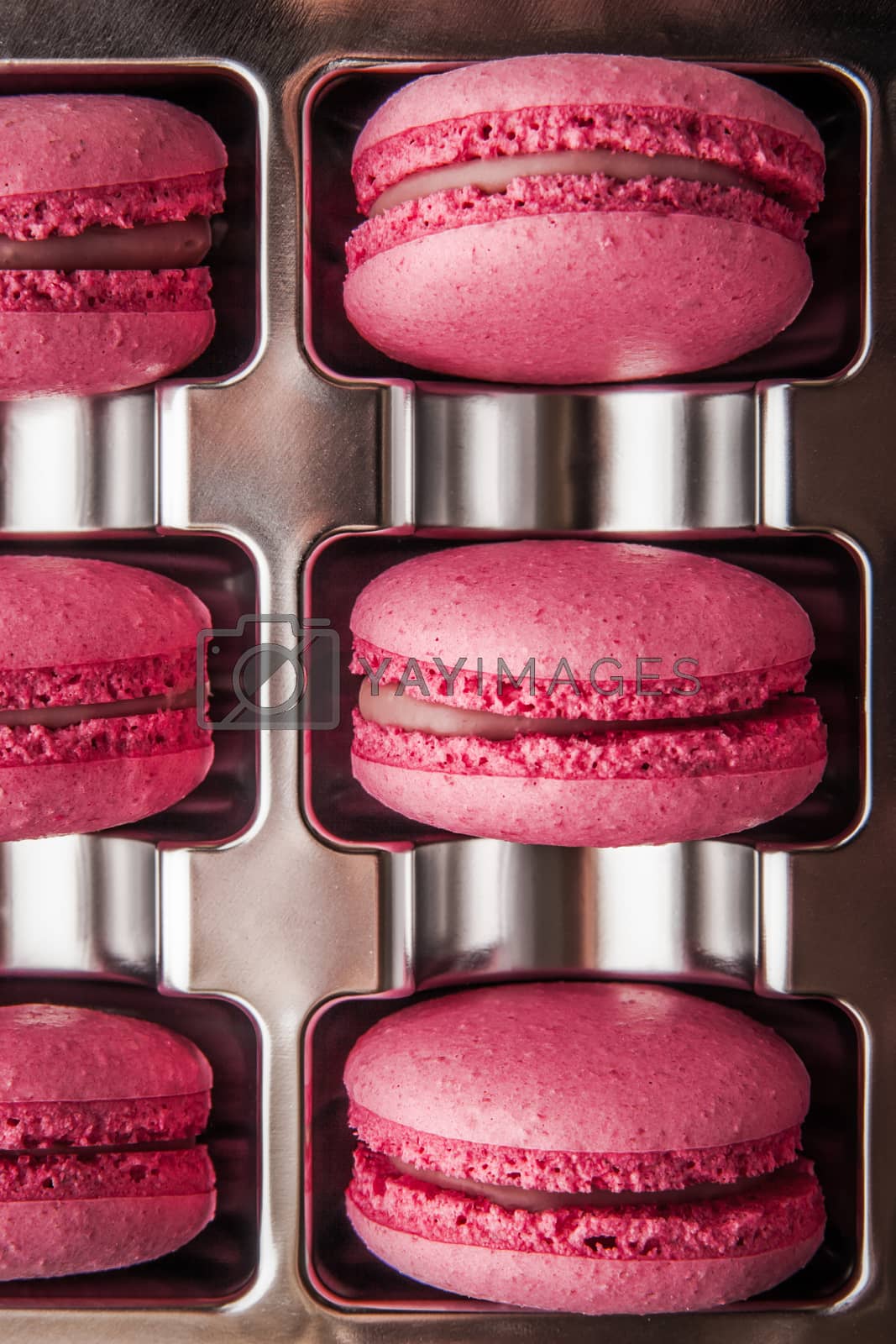 Royalty free image of Macaroon raspberry in a box of foil by Deniskarpenkov
