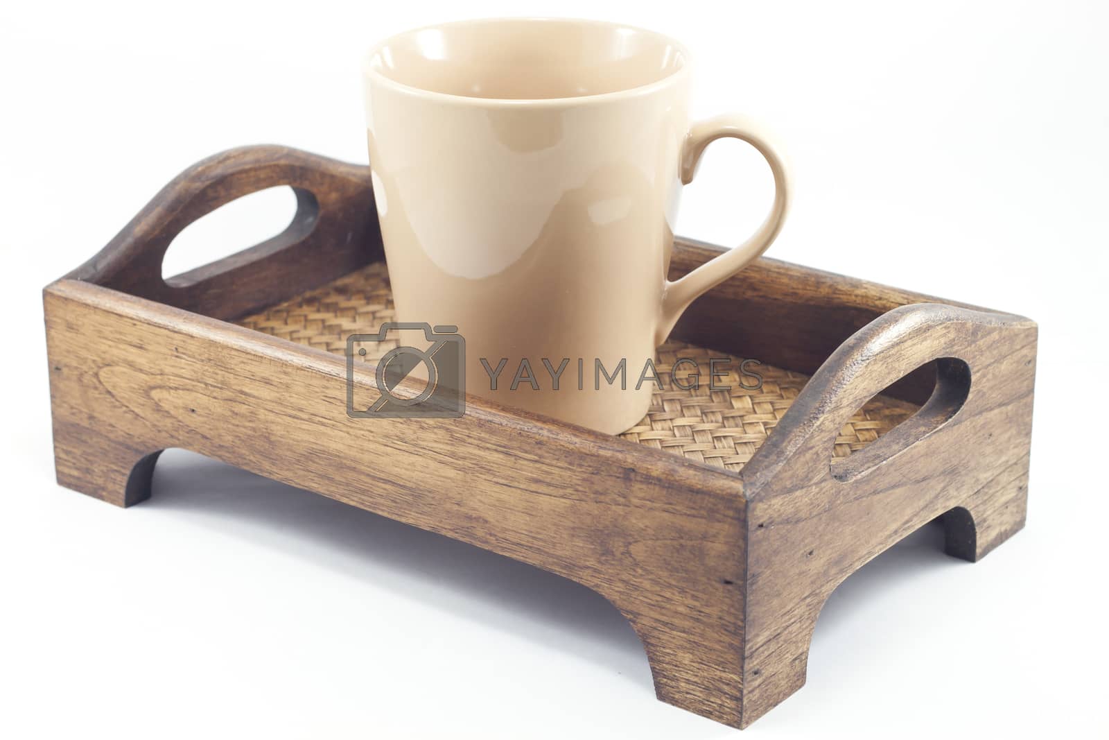 Royalty free image of Brown mug on wooden tray isolated on white background by punsayaporn