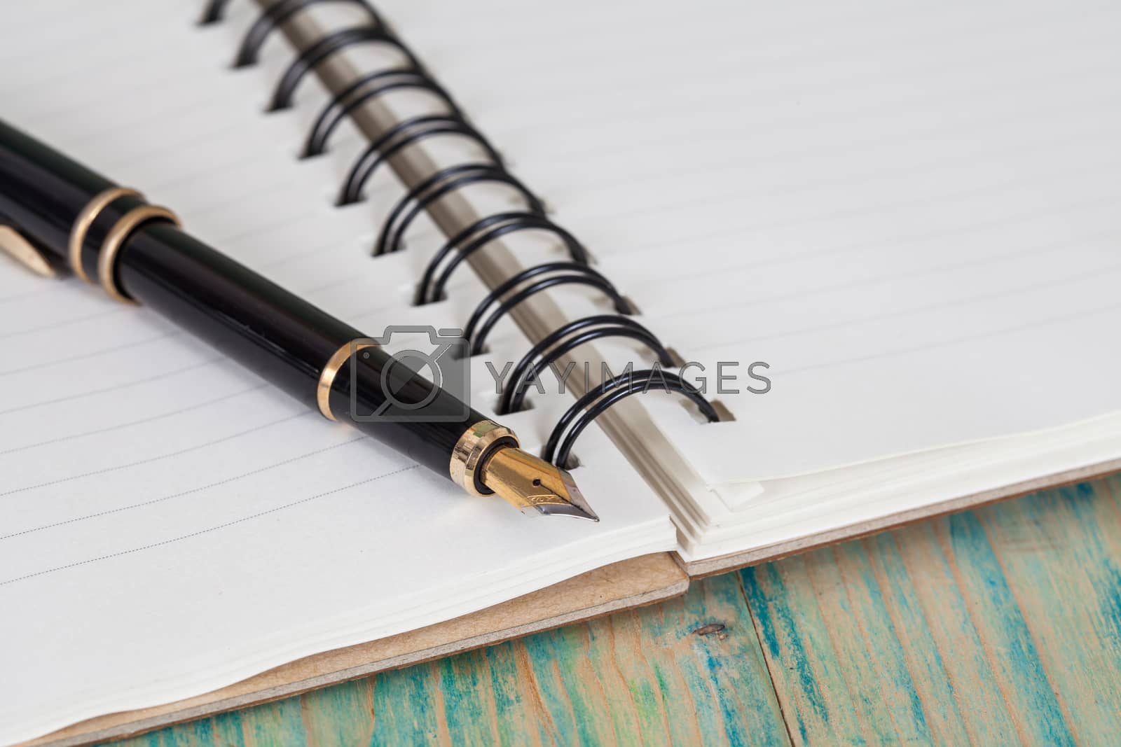 Royalty free image of selective focus of the  pen on opened lined diary book ,  by amnarj2006
