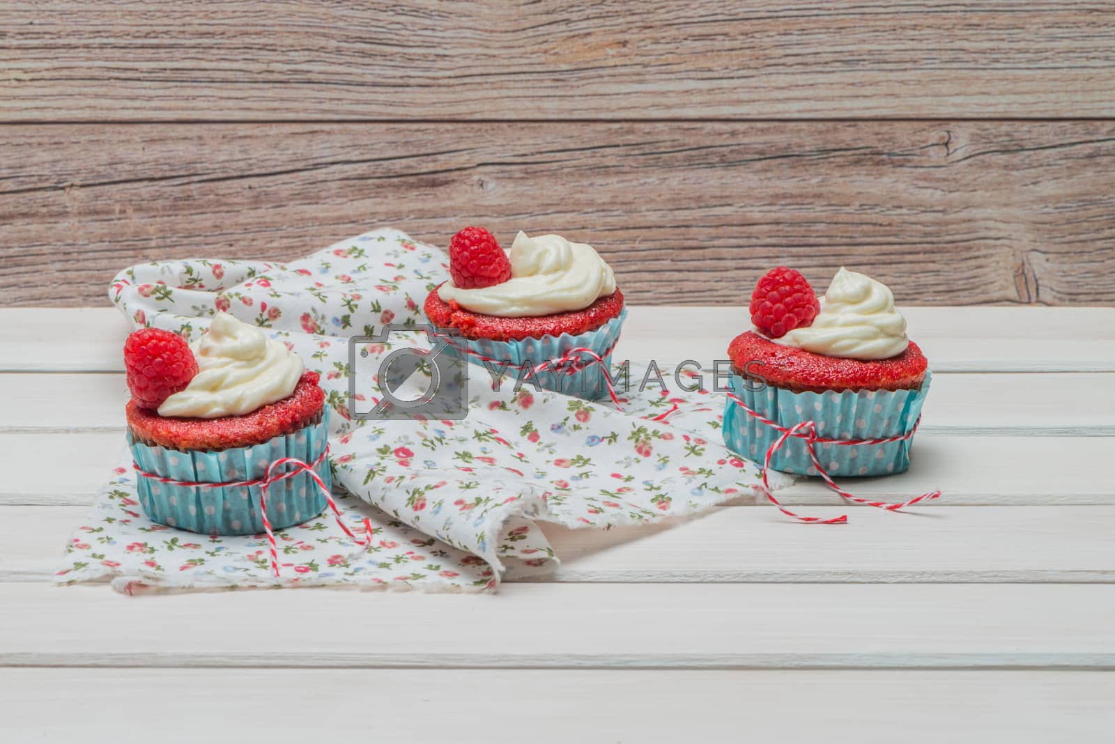Royalty free image of Red cupcakes with cream cheese frosting by homydesign