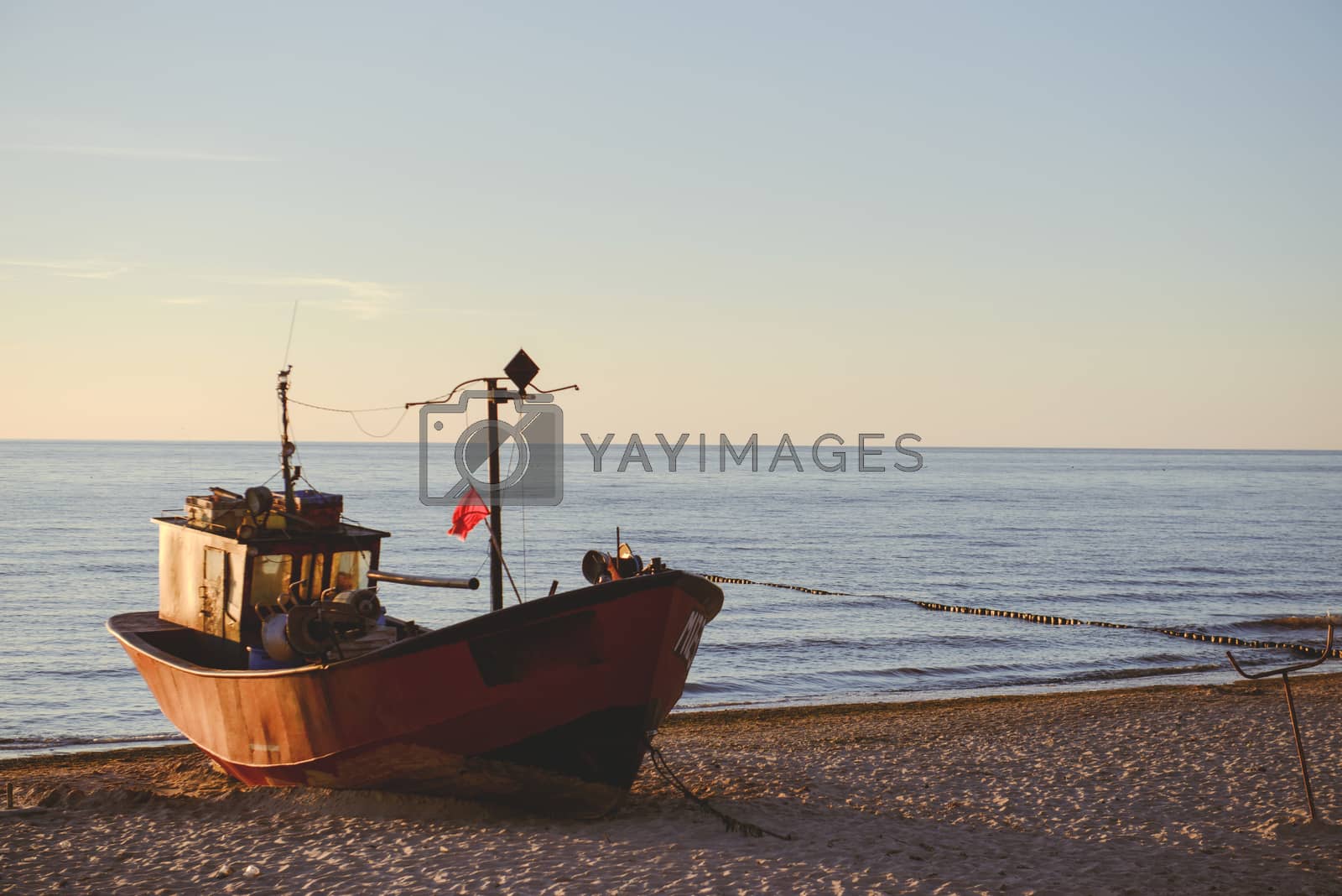 Royalty free image of fisherman boats at sunrise time on the beach by Brejeq