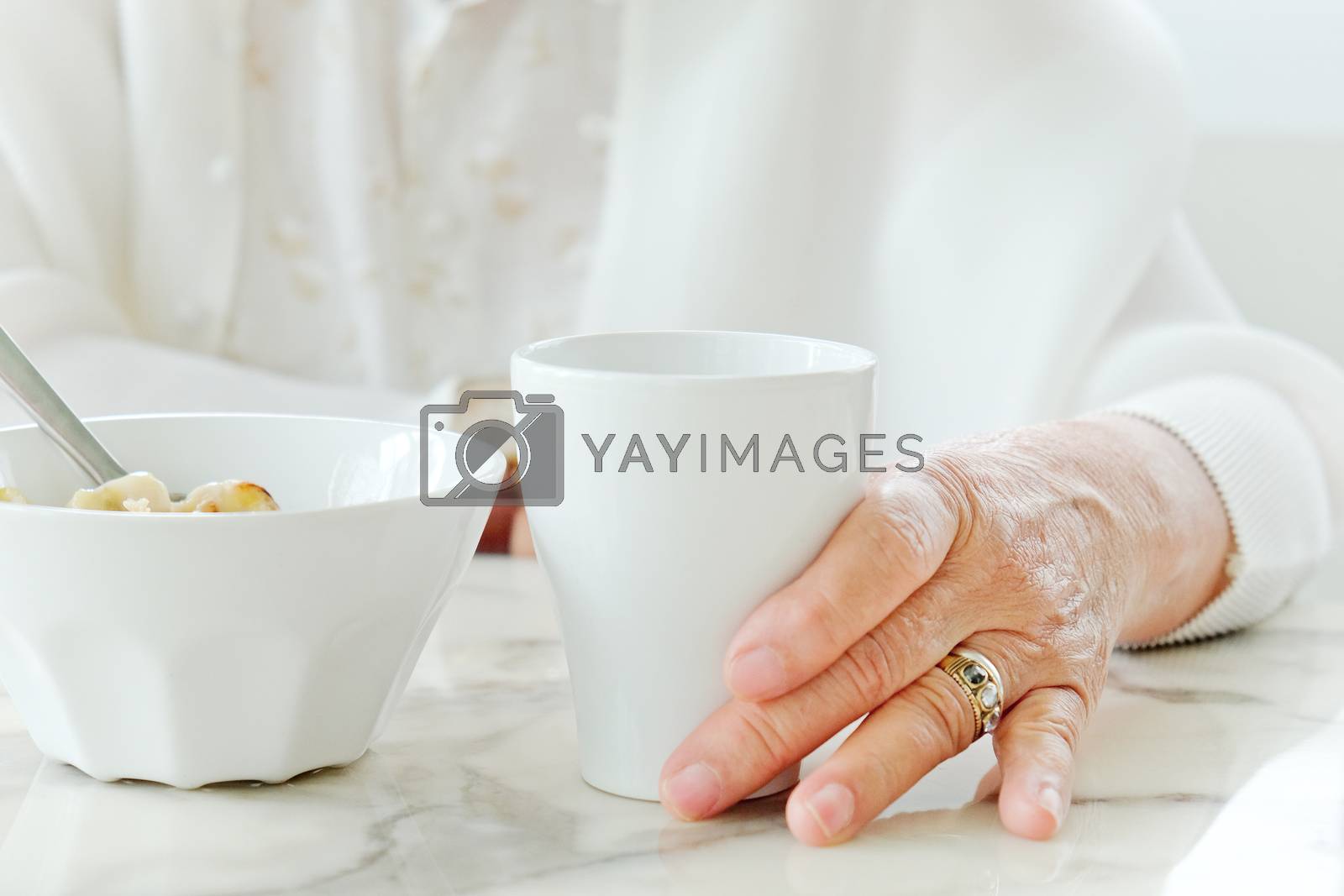Close up image of senior women with drink, meal time
