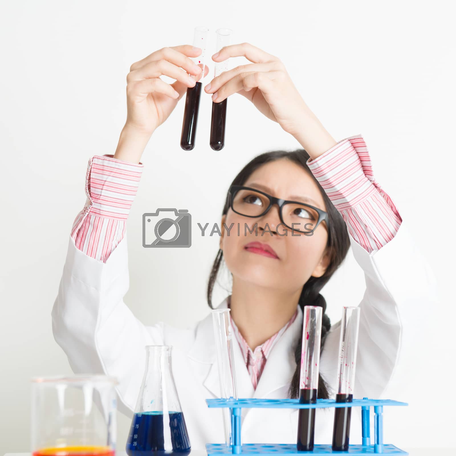 Royalty free image of Young female scientist doing research by szefei