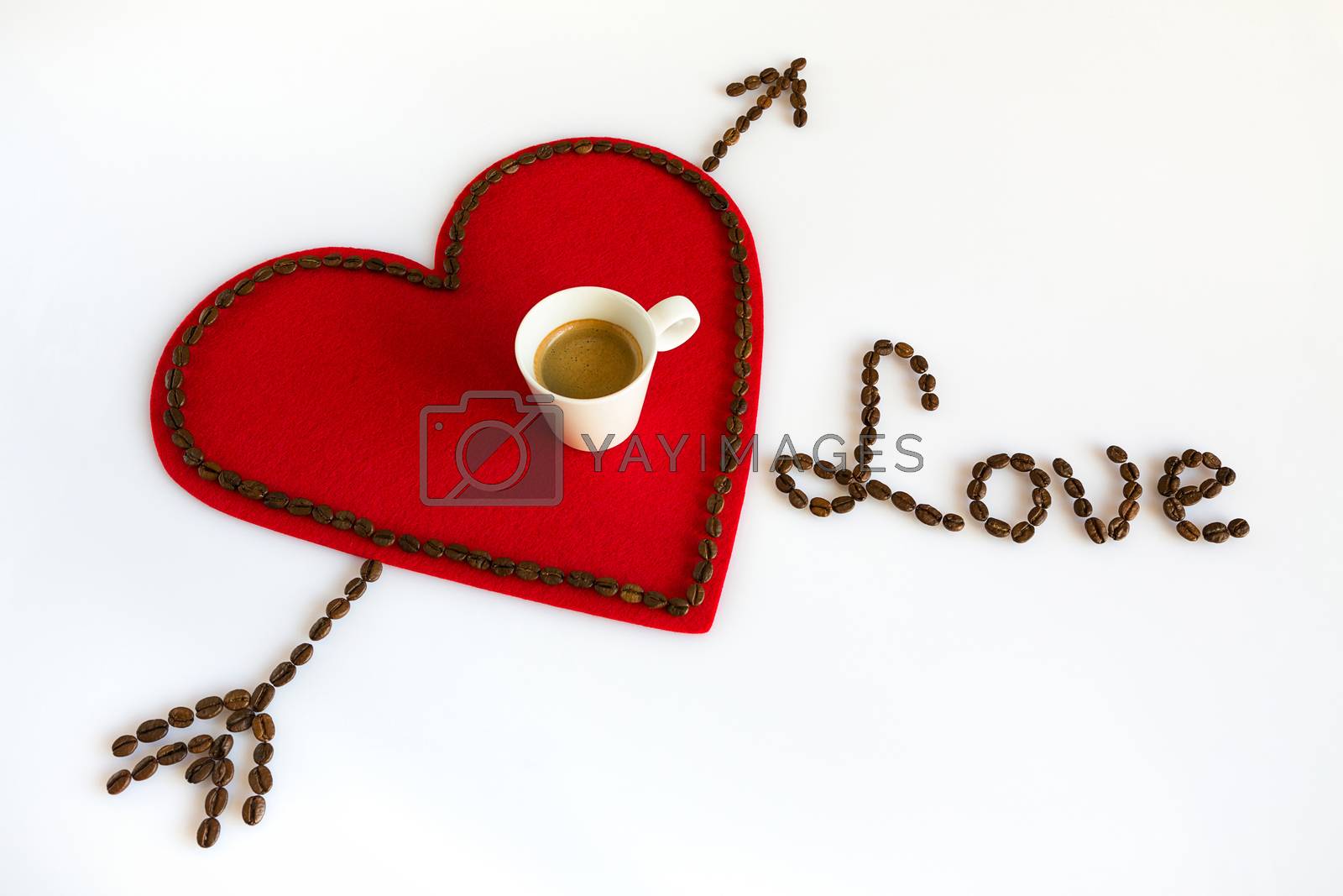 Royalty free image of Cup of coffee on a red felt heart with arrow and love by LuigiMorbidelli