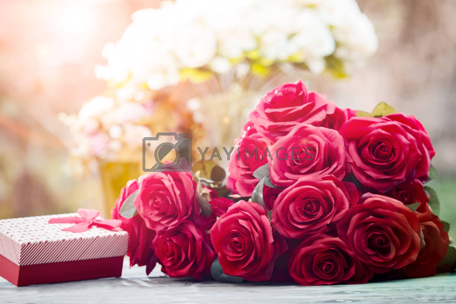 Royalty free image of red roses flowers with valentine festival gift and beautiful blu by khunaspix