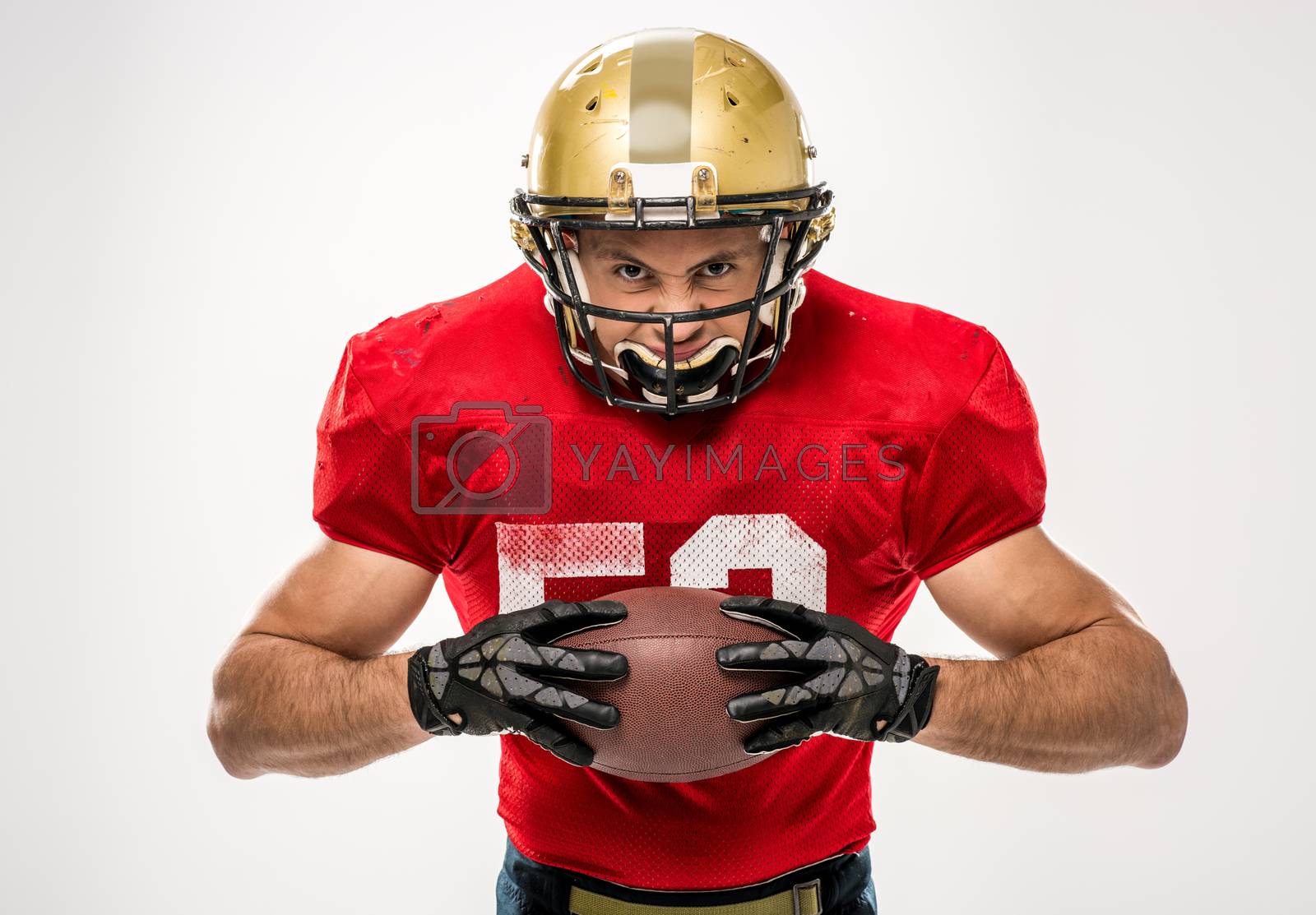 Royalty free image of Football player holding ball by LightFieldStudios