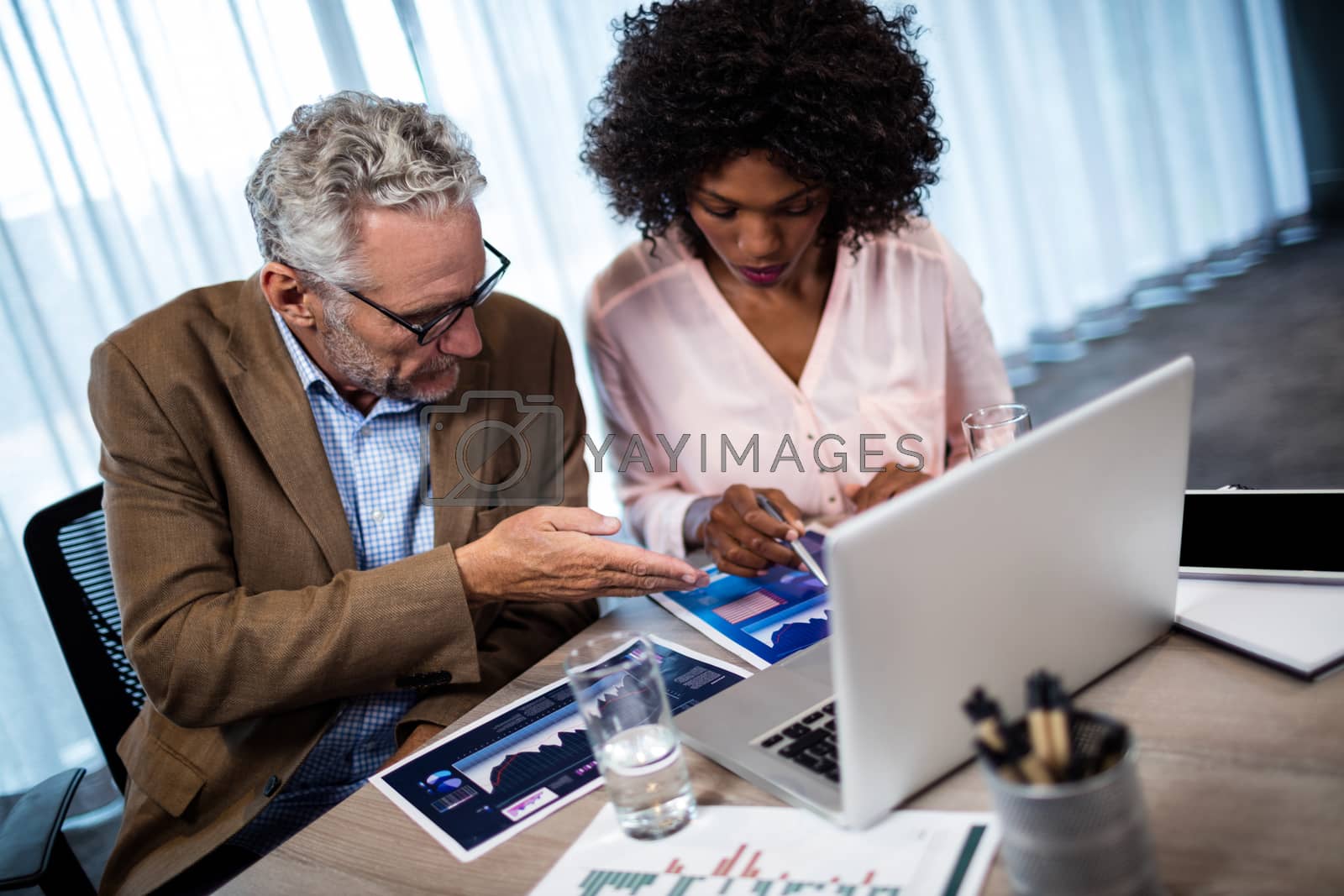 Royalty free image of Two businessmen working on a computer by Wavebreakmedia