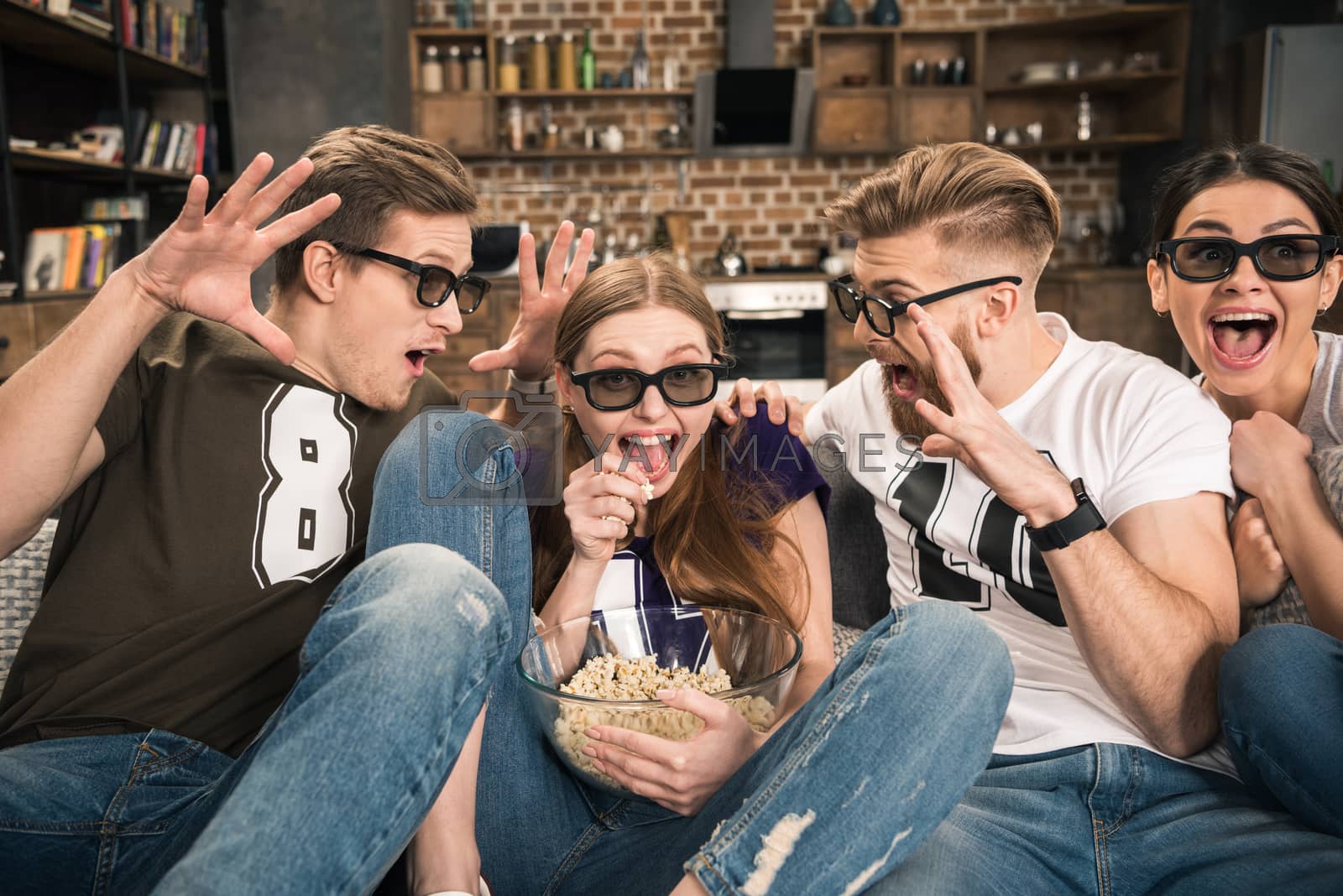 Royalty free image of excited friends in 3D glasses watching movie at home by LightFieldStudios