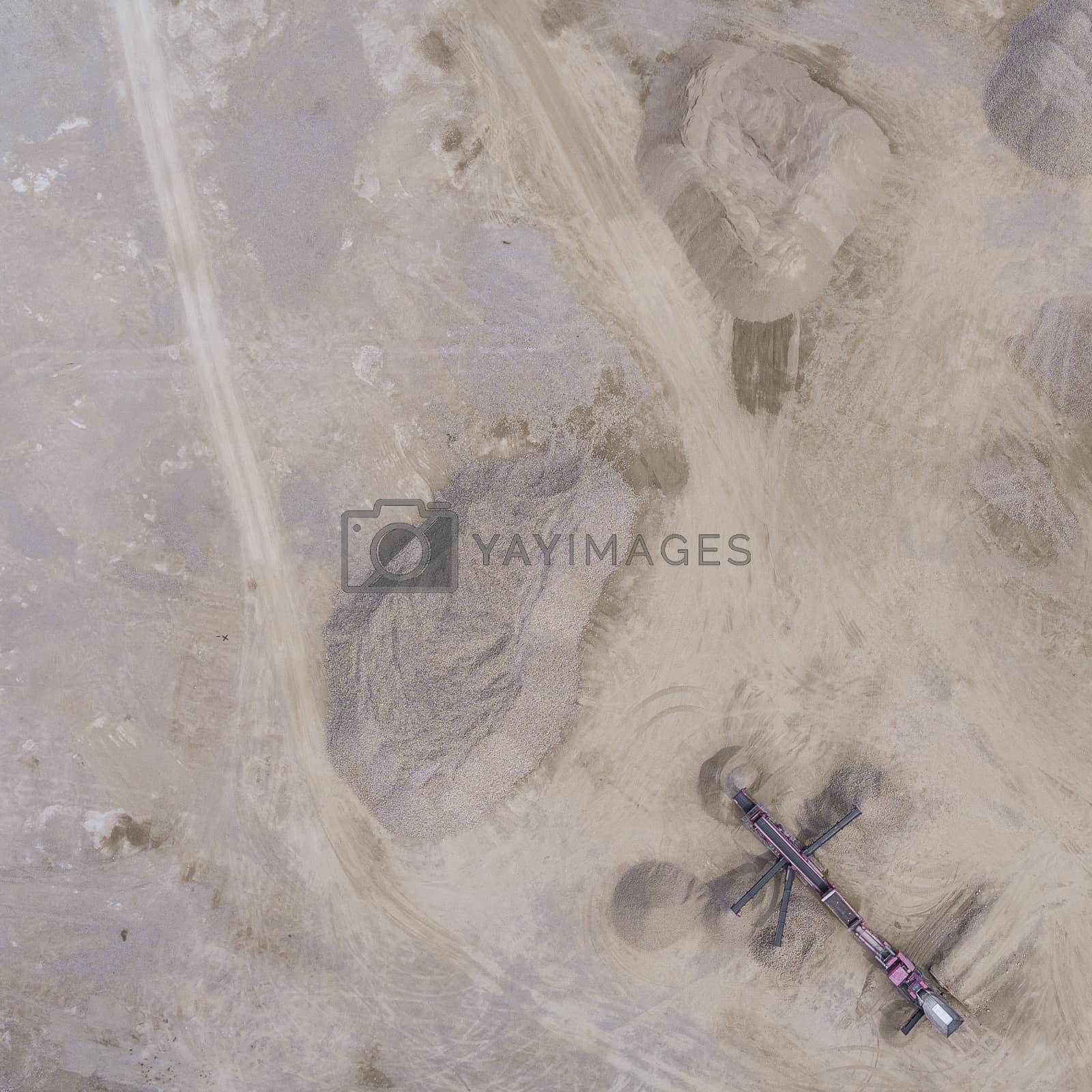 Royalty free image of Aerial view of excavator and truck working on the field of sand  by mariusz_prusaczyk