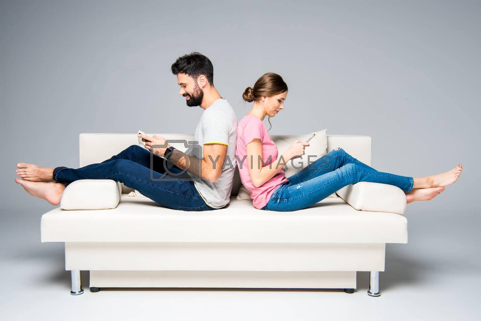 Royalty free image of Couple using smartphones  by LightFieldStudios