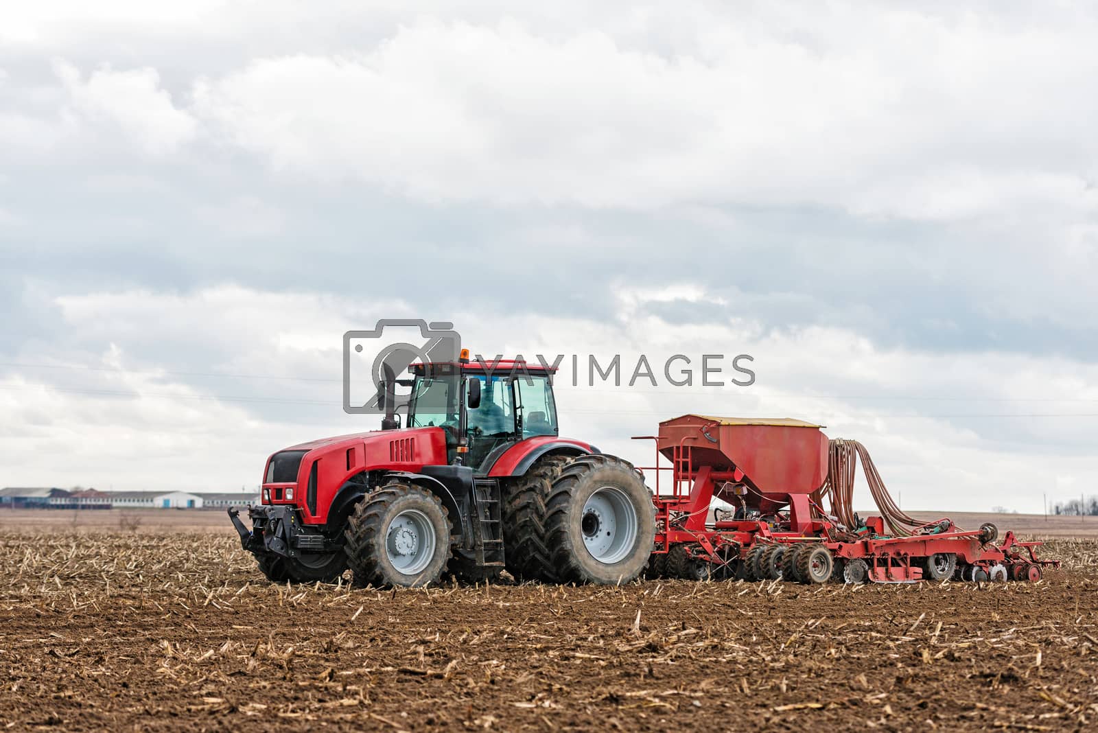 Royalty free image of Farmer tractor working in the field. Spring time for sowing. Pla by Draw05