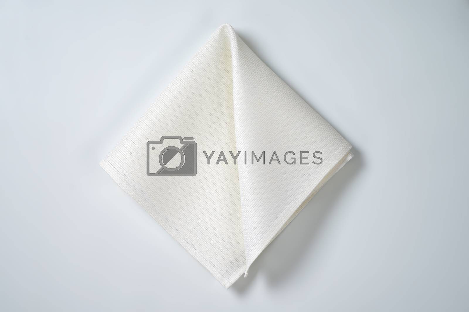 Royalty free image of folded white napkin by Digifoodstock