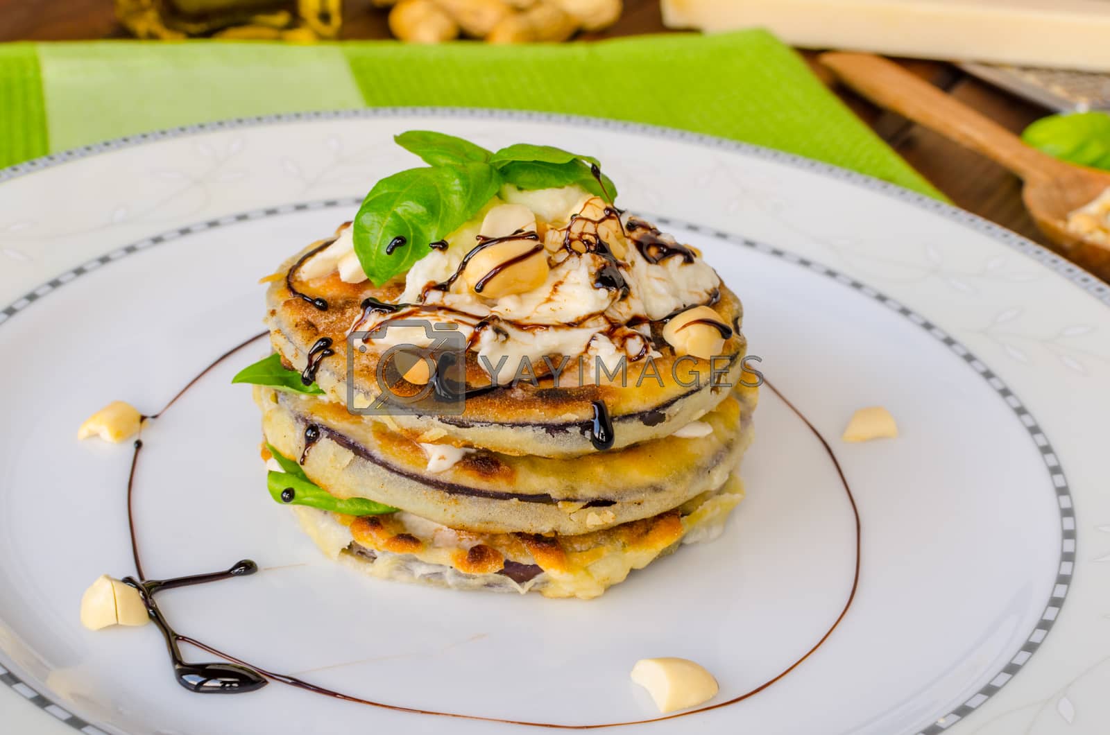 Royalty free image of Grilled eggplant with feta cheese,parmesan basil, nuts by Peteer