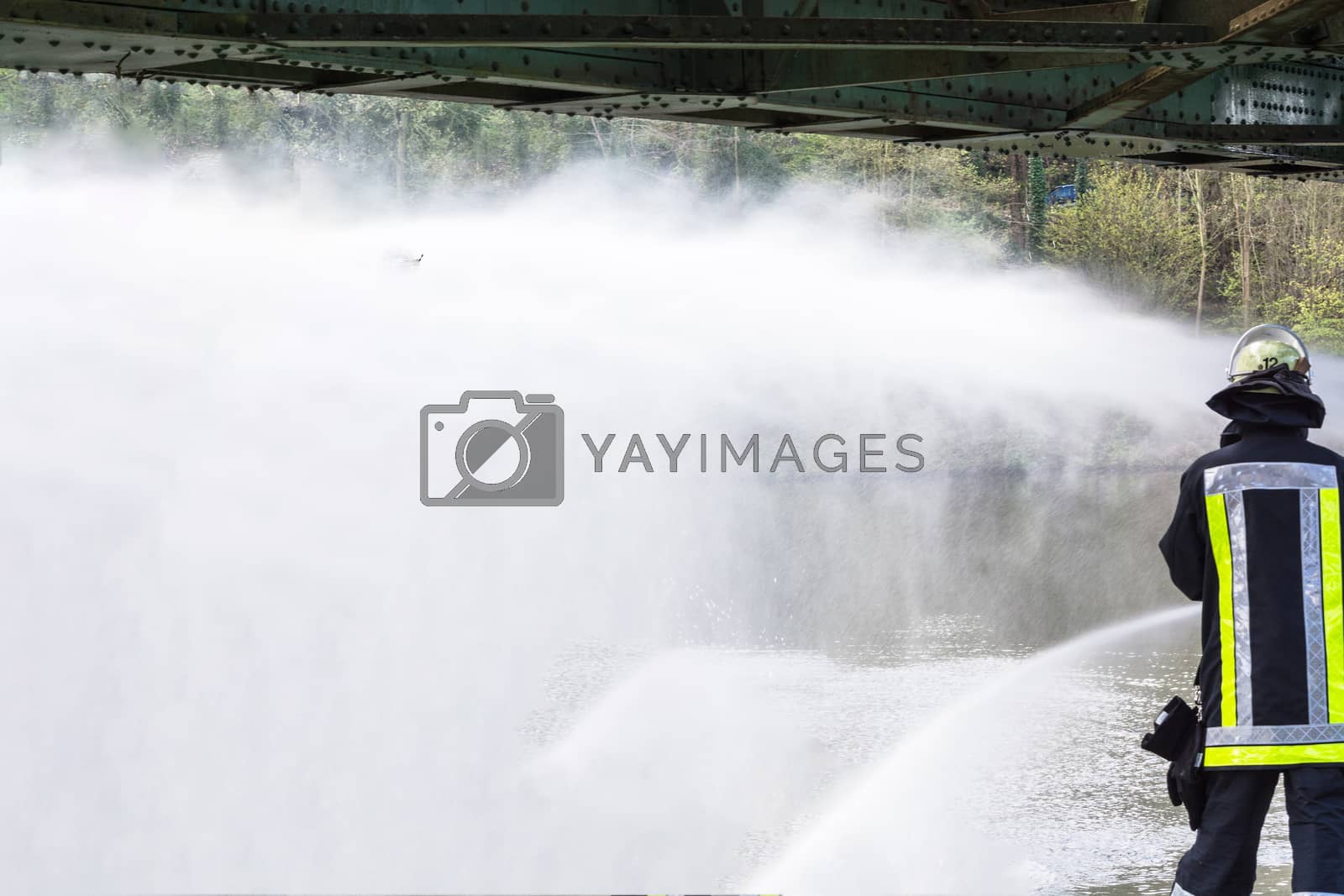 Royalty free image of Fire department sprayed extinguishing water during an exercise. by JFsPic