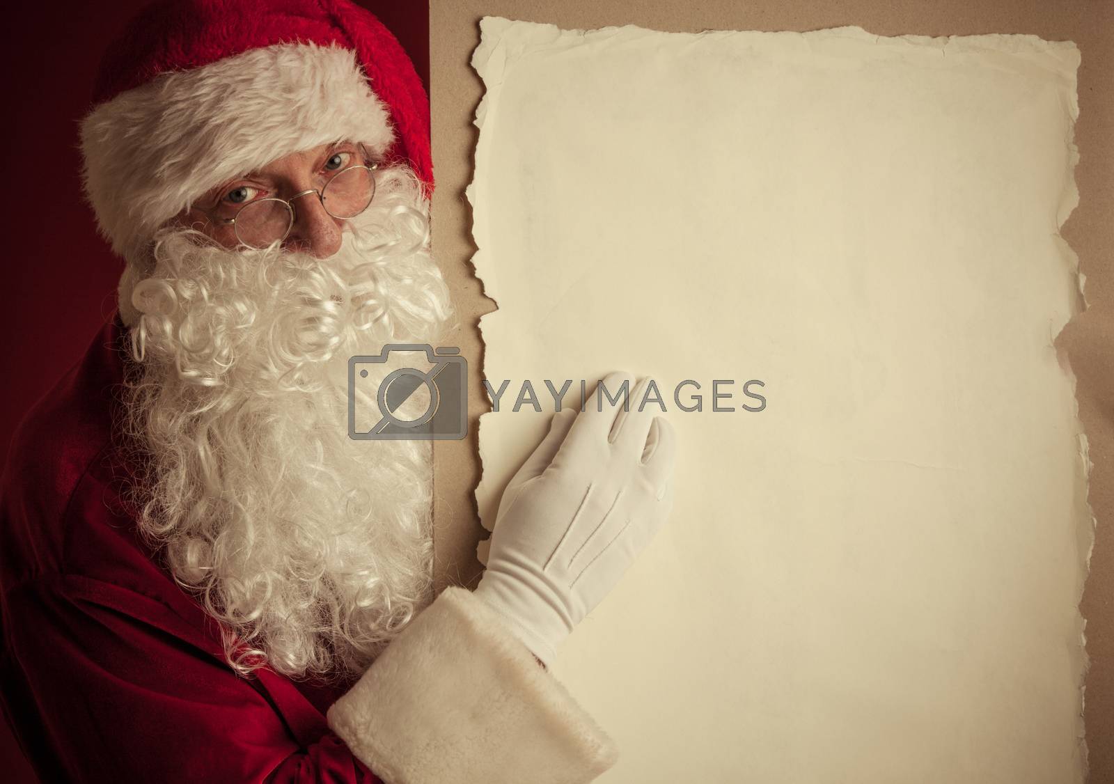Royalty free image of Santa Claus with vintage paper by ALotOfPeople