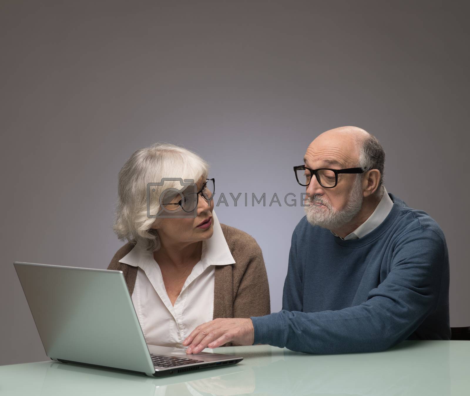 Royalty free image of Senior couple looking at laptop by ALotOfPeople