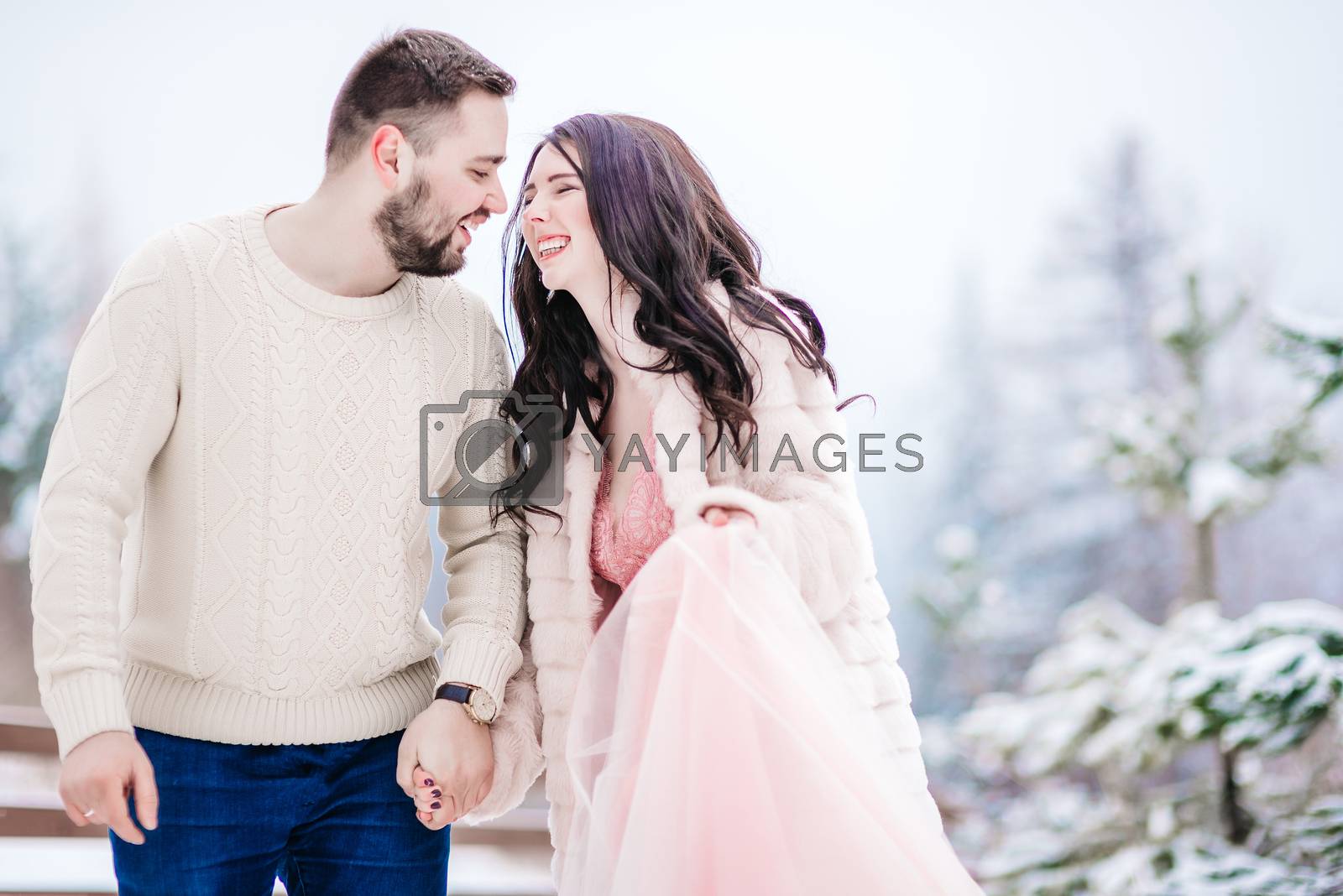 Royalty free image of young couple on a walk in the snowy mountains by Andreua