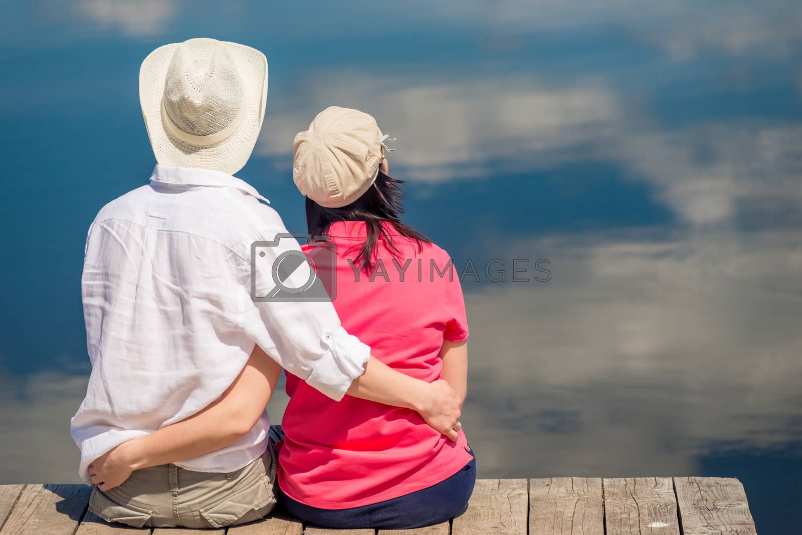 Royalty free image of happy couple hugging and enjoying rest near beautiful lake, view by kosmsos111
