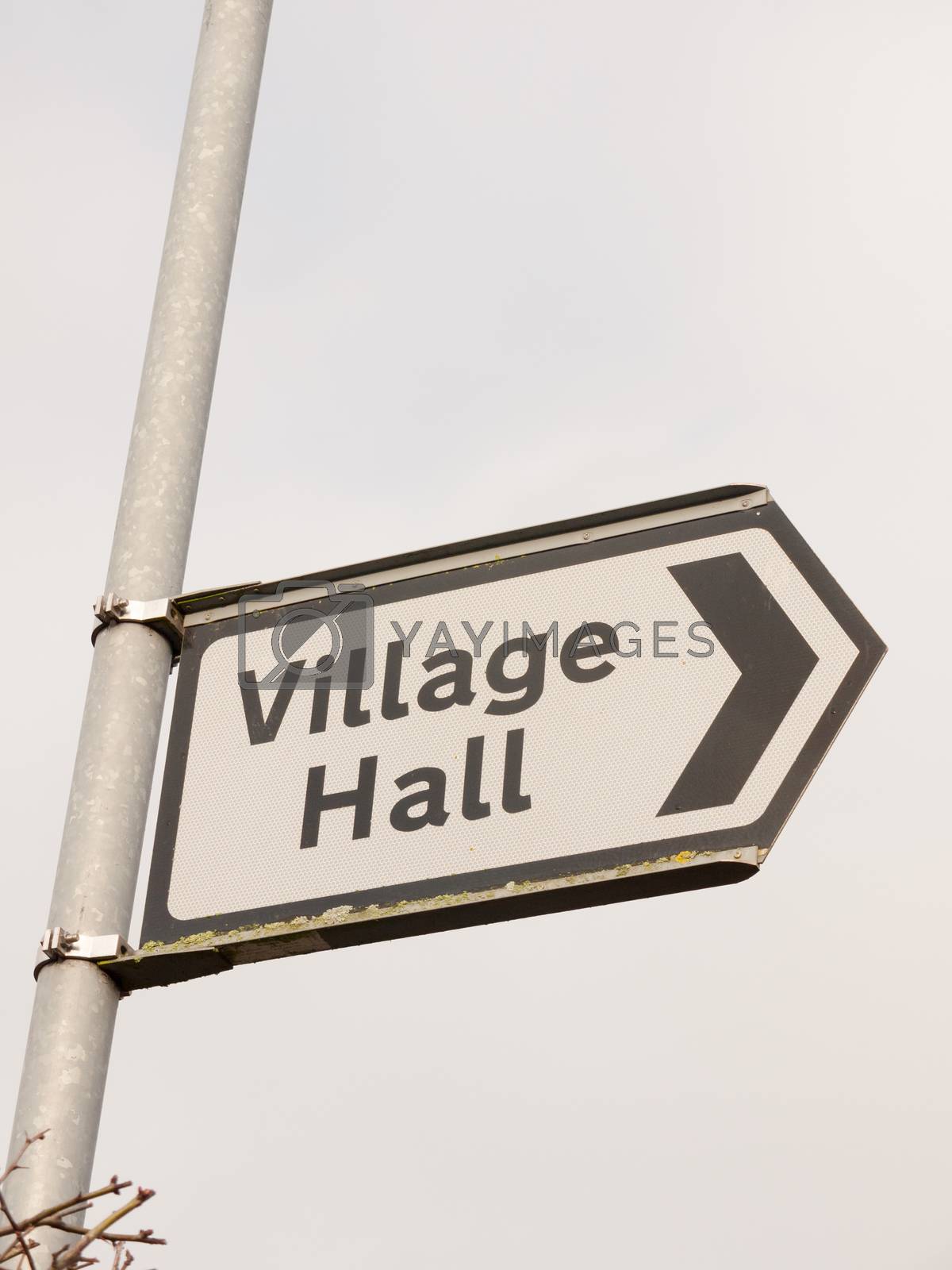 Royalty free image of white and black village hall sign post direction street by callumrc