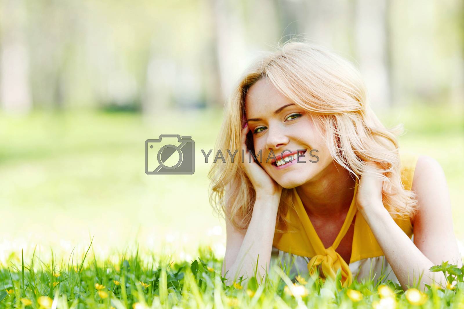 Royalty free image of Young woman on grass by Yellowj