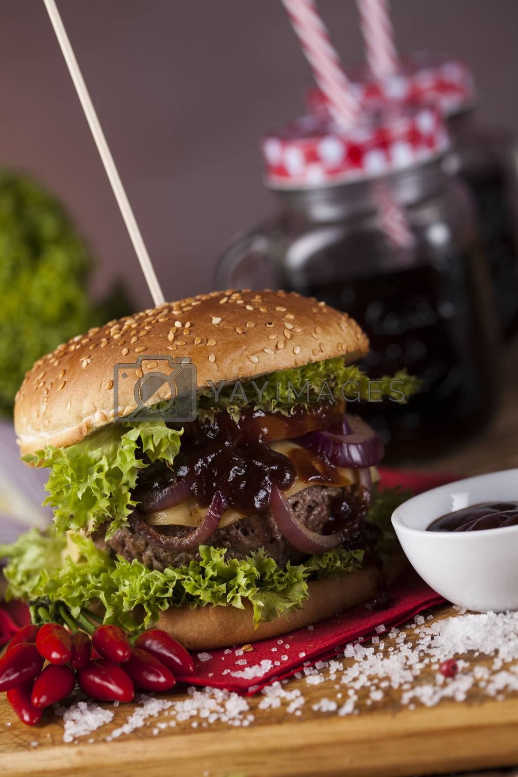 Royalty free image of Home made burgers on wooden background
 by JanPietruszka