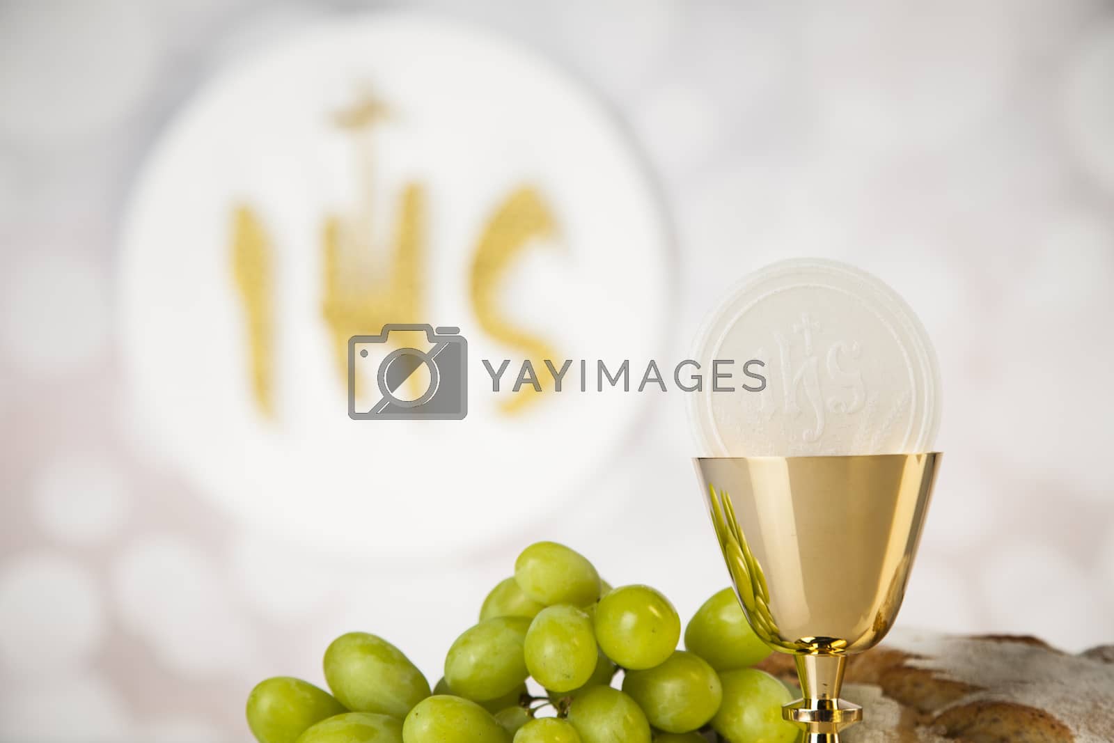Royalty free image of Holy communion a golden chalice, composition isolated on white by JanPietruszka