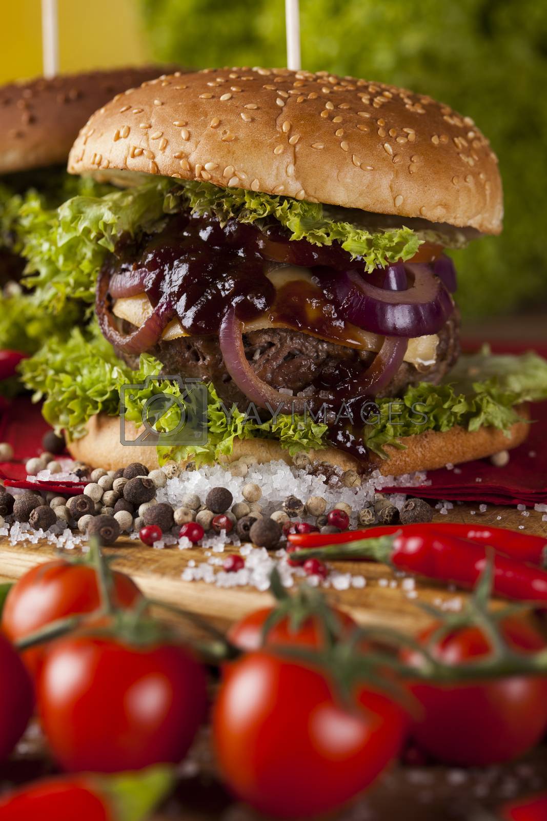 Royalty free image of Fresh burger closeup on wooden desk background by JanPietruszka