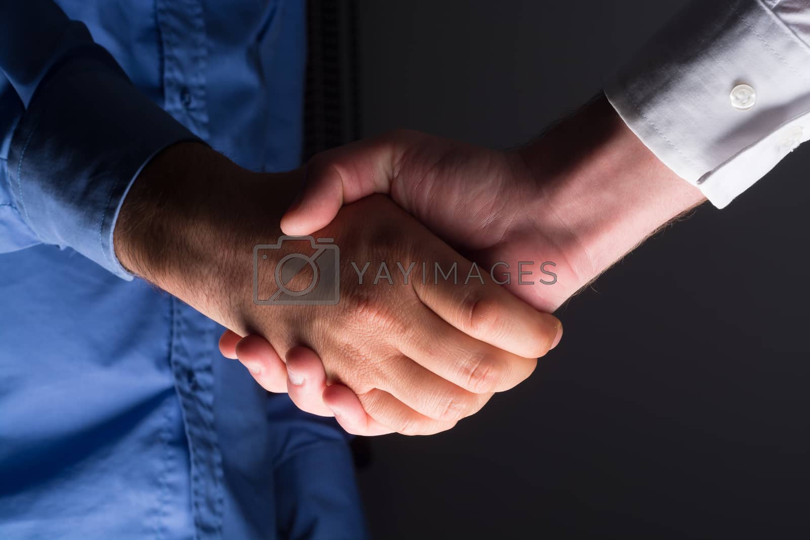 Royalty free image of Two male businessman hands shaking by adamr