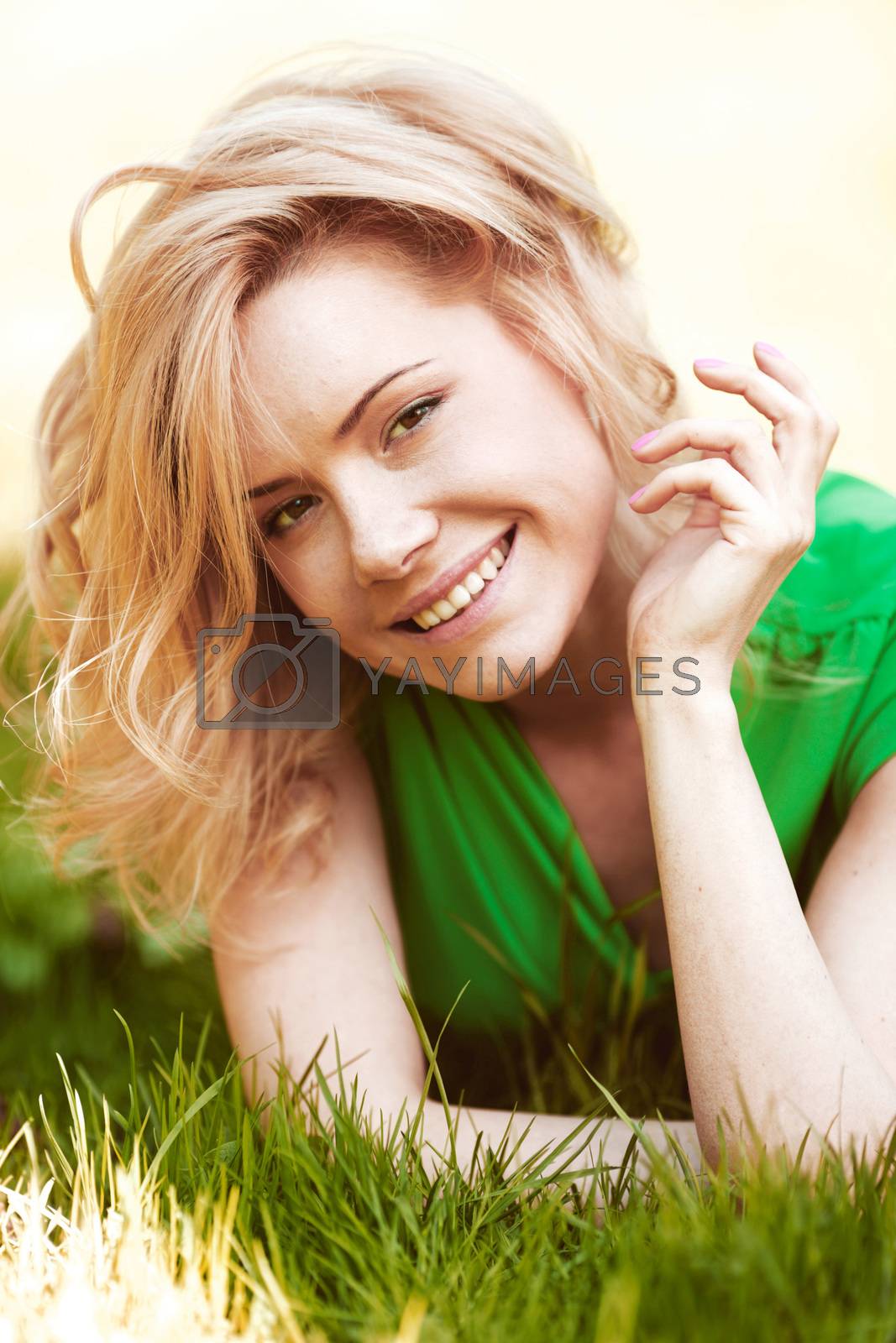 Royalty free image of Young woman on grass by Yellowj