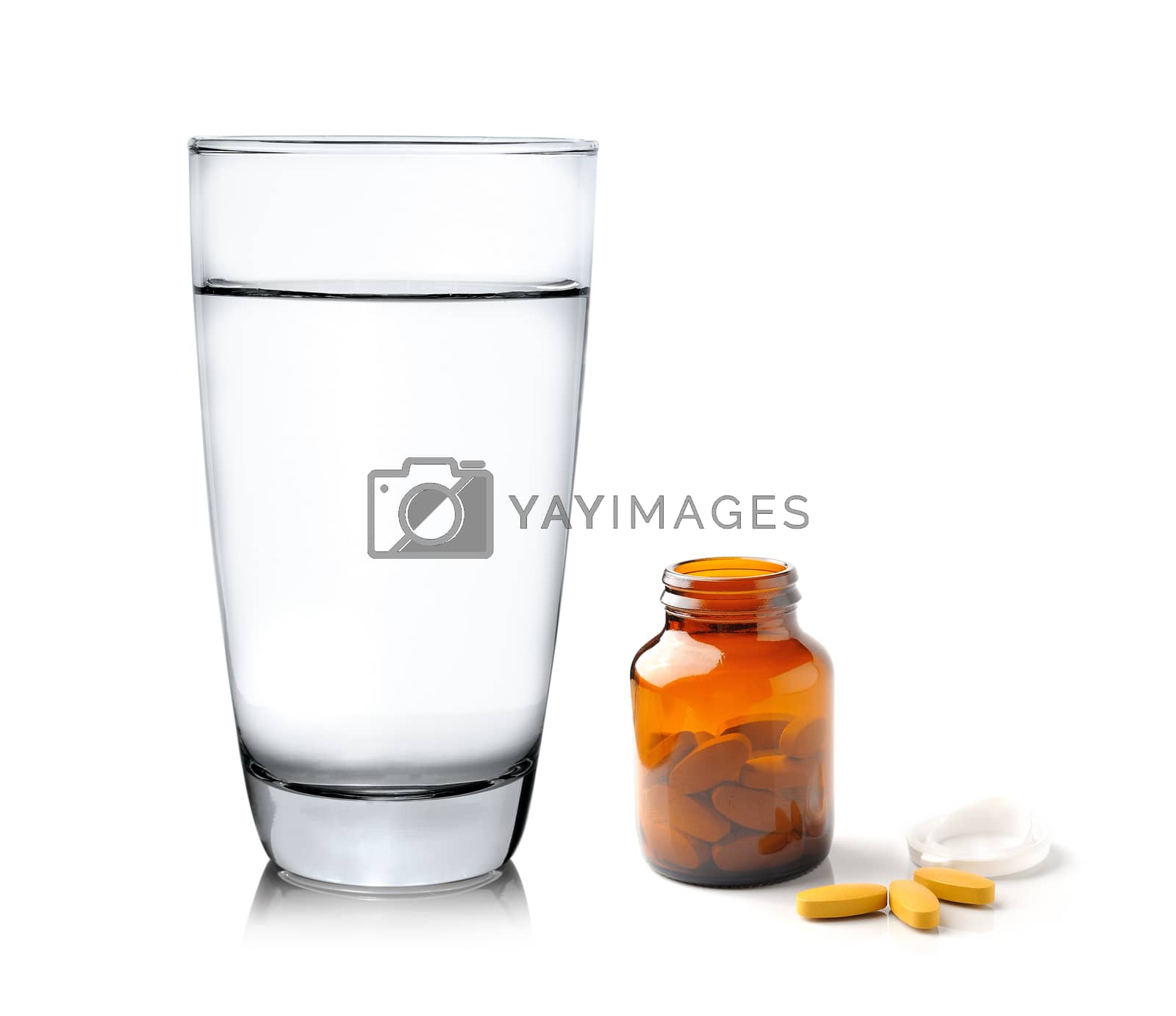 Royalty free image of Pills from bottle and Glass of water isolated on white backgroun by sommai