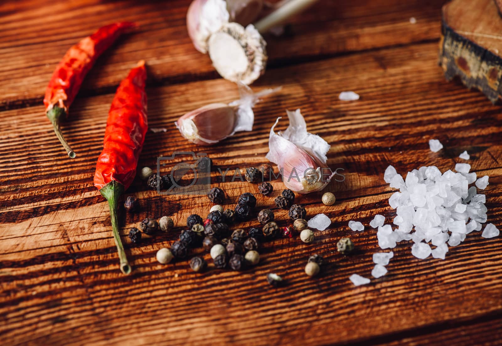 Royalty free image of Some condiment on wooden table by Seva_blsv
