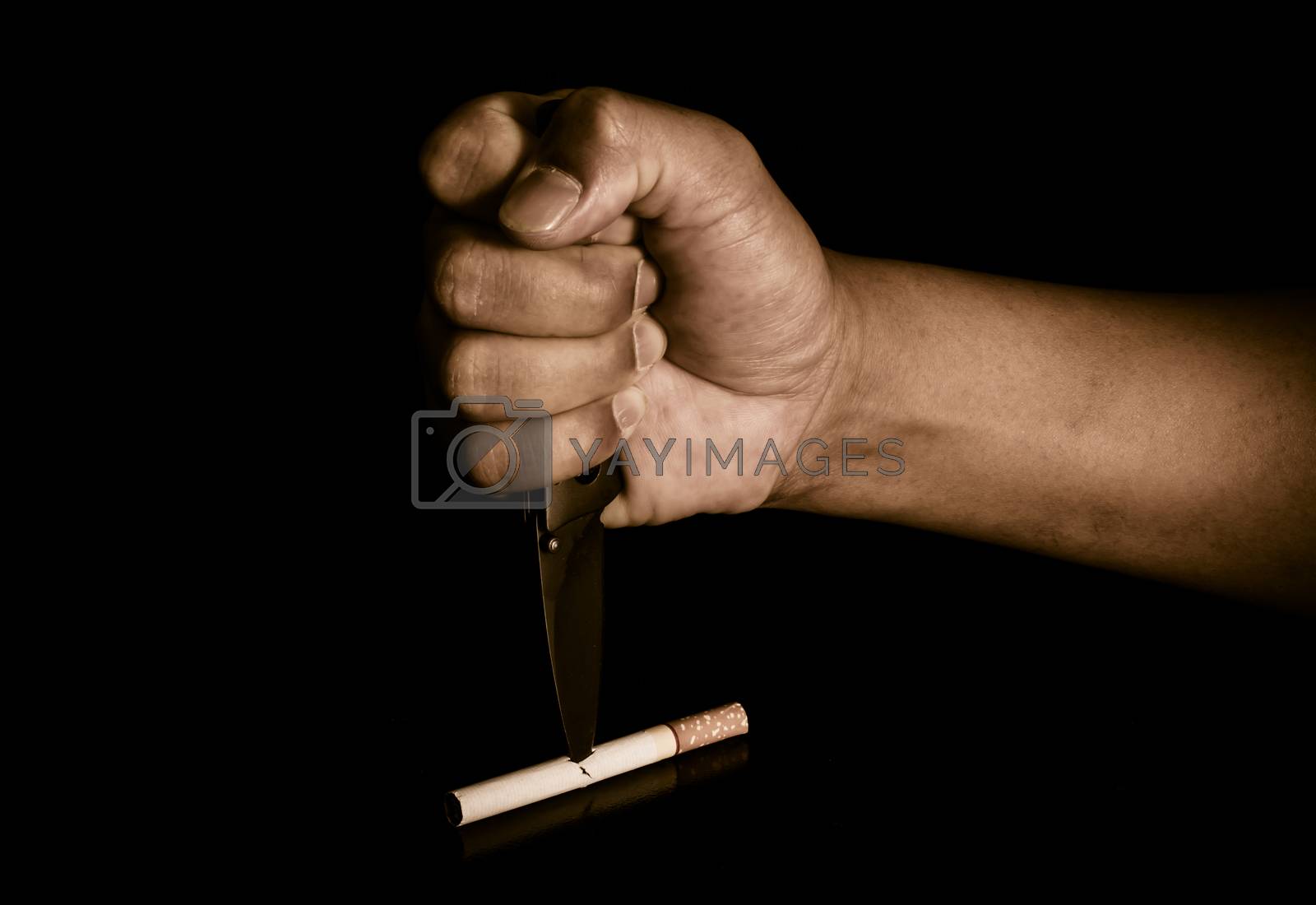 Royalty free image of Handle knife stabbed into cigarettes concept eliminate smoking, quit smoking. by photobyphotoboy