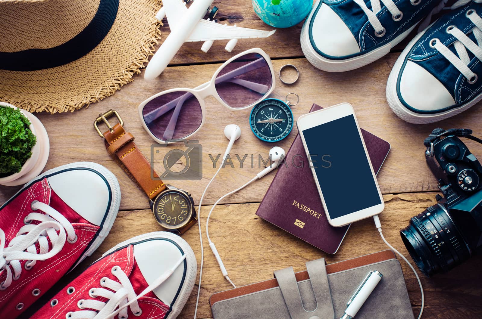 Royalty free image of Travel accessories for trip on wood by photobyphotoboy