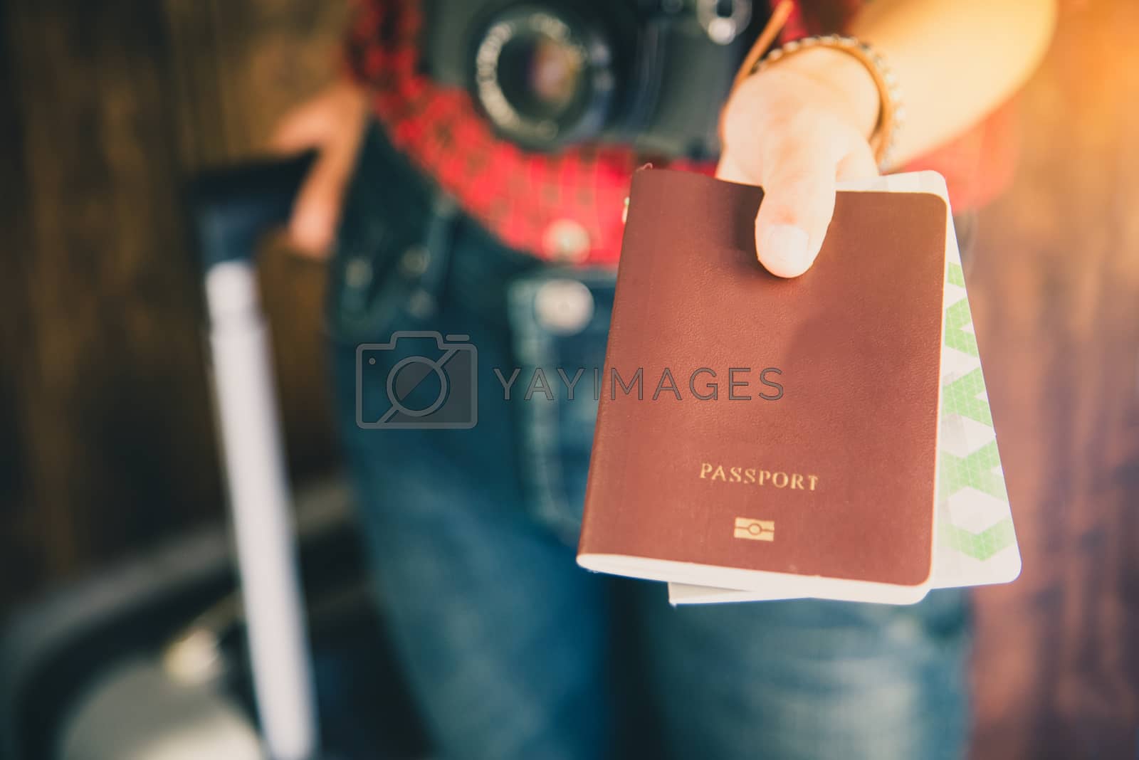 Royalty free image of Passengers hold passports and travel luggage tickets to show to  by photobyphotoboy