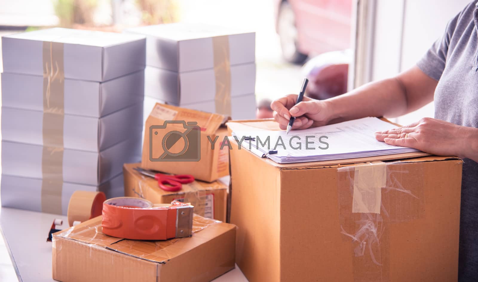 Royalty free image of The officer is checking the goods in the warehouse. by photobyphotoboy