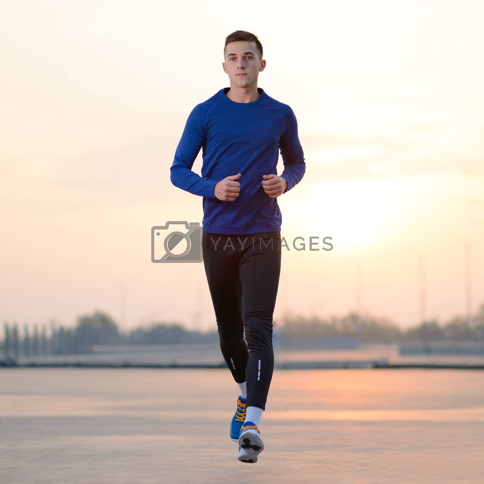 Royalty free image of Young Sports Man Running at Sunset. Healthy Lifestyle and Sport Concept. by maxpro